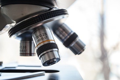 laboratory equipment - optical microscope.
microscope is used for conducting planned, research experiments, educational demonstrations in medical and health institutions, laboratories. close up photo.