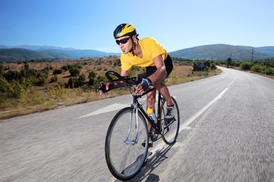 cyclist riding a bike on an open road
