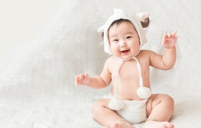 soft focus cute asian male baby sitting on a towel. 