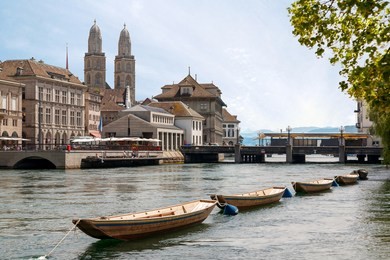 view of zurich from the river, with grossmunster church and embankment in sight.