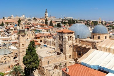church of the holy sepulchre, domes, minarets and rooftops of the old city of jerusalem, israel as seen from above.