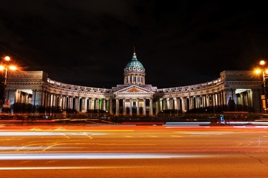 st petersburg, russia. illuminated cathedral of our lady of kazan, russian orthodox church in saint petersburg, russia at night with car traffic trail lights at the forefront