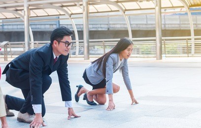 the businessman and businesswoman ready to run on start position with challenge and commitment to success