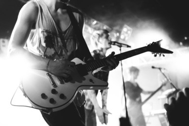 guitarist close up on a stage playing rock, black and white shot