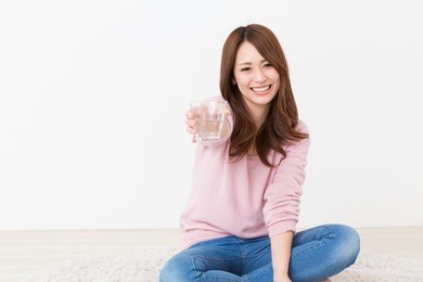 young attractive asian woman who drinks water