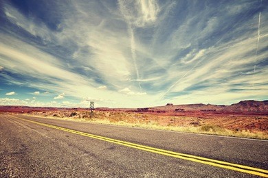 vintage toned picture of a scenic desert road.