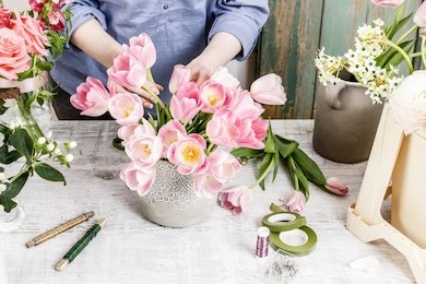 florist at work: woman arranging flowers. bouquet of pink tulips. 
