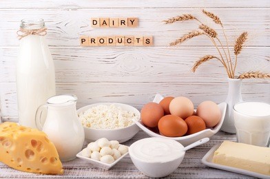 dairy products on wooden table. milk, sour cream, cheese, egg, yogurt and butter. healthy food, diet concept. copy space