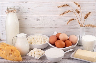 dairy products on wooden table. milk, sour cream, cheese, egg, yogurt and butter. healthy food, diet concept. copy space