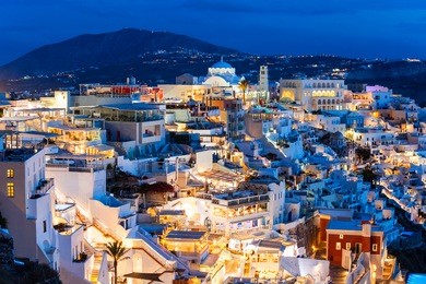 fira town aerial panoramic view, santorini at sunset. fira is the modern capital of the santorini island in cyclades, greece.