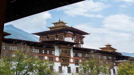 beautiful view of punakha dzong with blue sky, clouds, mountains, river, trees and sky. 