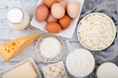 dairy products on wooden table. milk, sour cream, cheese, egg, yogurt and butter. healthy food, diet concept. copy space. top view