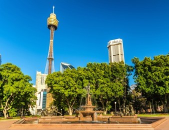 the archibald fountain in hyde park with modern building in the background - sydney, australia