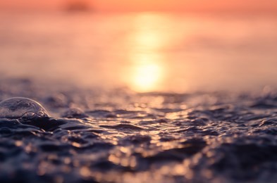 blur tropical sunset beach with bokeh light wave abstract background. copy space of outdoor summer vacation and business travel adventure concept. vintage tone filter effect color style.