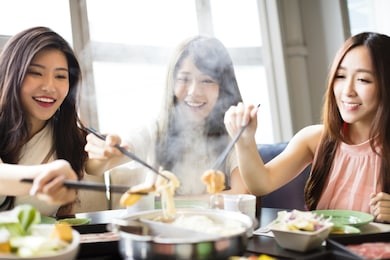 happy young women group  eating hot pot 