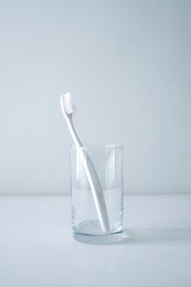white toothbrushes in glass