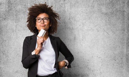 business black woman holding a credit card