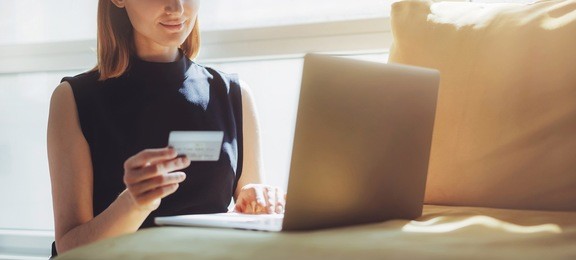 business woman waiting for confirmation of her online order at home, blogger shopping online and using gold credit card