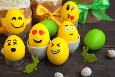 easter eggs on wooden background. smile faces aggs.