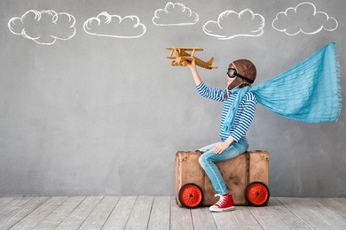 child pretend to be pilot. kid having fun at home. summer vacation and travel concept
