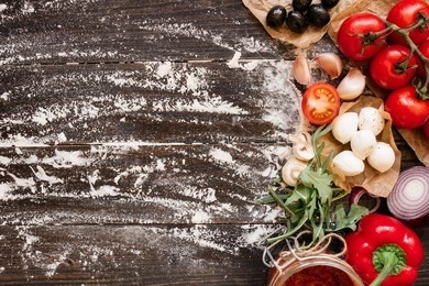 cooking pizza. pizza ingredients on the wooden table with copy space, top view.