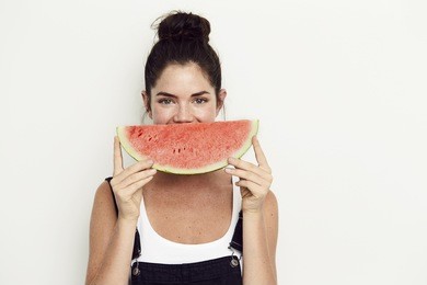 grinning watermelon girl against white background