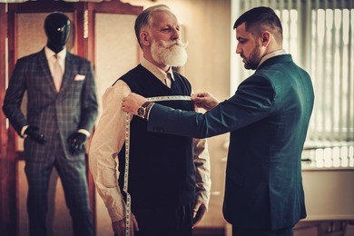 tailor measuring client for custom made garment