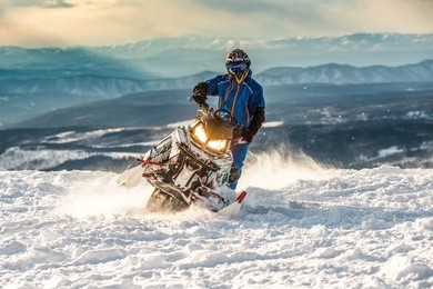 rider on the snowmobile in the mountains ski resort in amut russia.