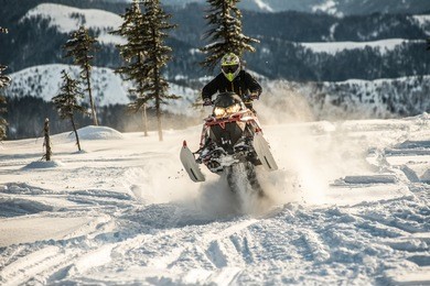 rider on the snowmobile in the mountains ski resort in amut russia.