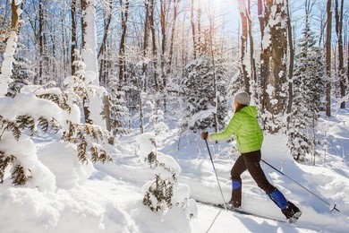 a young woman cross country skiing in ontario, canada.