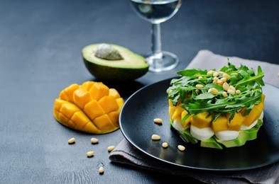 avocado mango arugula pine nuts mozzarella salad. toning. selective focus