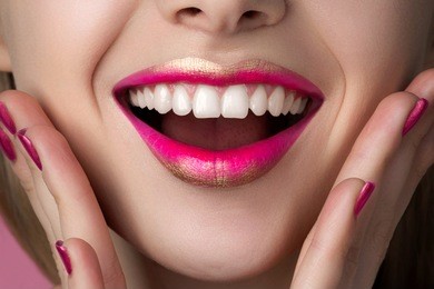 close up view of beautiful happy surprised woman lips with fashion make up. studio shot. lips cosmetics, healthy skin and tooth, modern makeup or happy woman concept