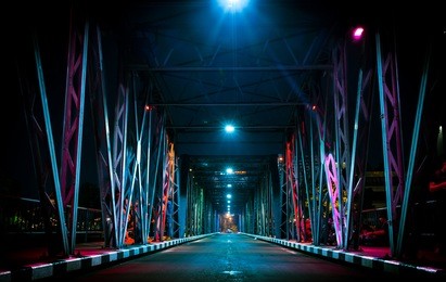 colorful light on iron bridge at night time in chiang mai, thailand