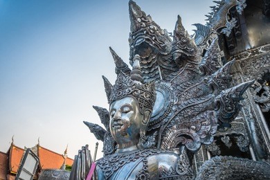 statue engraved from silver in buddhist temple at chiang mai, thailand