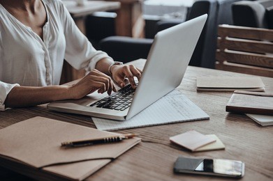 full concentration at work. close-up of african woman using computer while sitting in cafe