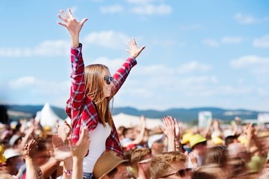 teenagers at summer music festival enjoying themselves
