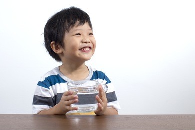 cute little asian boy drink water