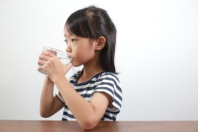 cute little asian girl drink water