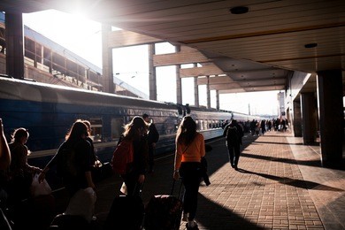 railway station in the city with silhouettes of running people.