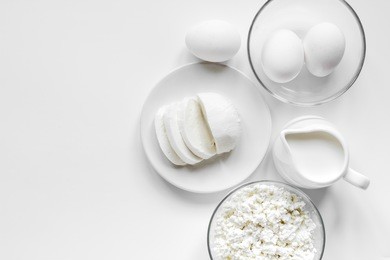 fresh dairy products on white table background top view mockup