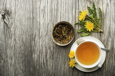 cup of healthy dandelion tea on wooden background. herbal medicine. 