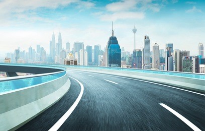 highway overpass motion blur effect with modern city skyline background . day time scene .