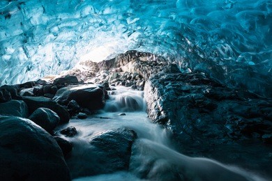 waterfall in an ice cave at breidamerkurjokull. an outlet glacier of the larger glacier of vatnajokull in southeastern iceland