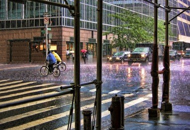 colorful, rainy, city intersection with traffic and cyclists