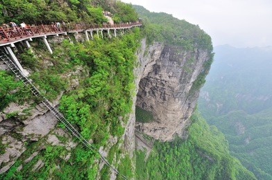 tianmen mountain within tianmen mountain national park, zhangjiajie, in northwestern hunan province, china.
view of the natural arch and the sidewalk.