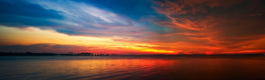 stunning panoramic view of the dark overcast sky . dramatic and picturesque evening scene. sea side of port klang ,strait of malacca, kuala lumpur ,malaysia .