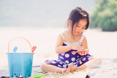 little asian girl playing on the beach.summer vacation and relax concept.
