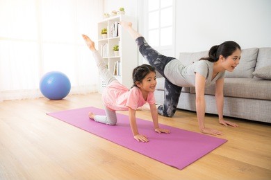 asian pretty mother and her youth kid daughter in the gym center doing stretching fitness exercise yoga together, parent accompany children sport concept.