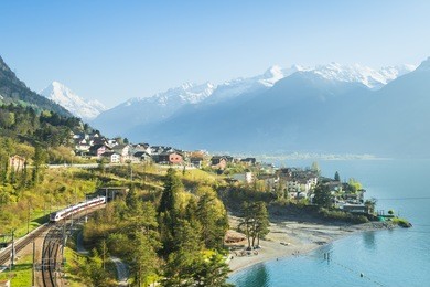 view of the small town in the alps mountains. railway along lake lucerne. canton of uri.