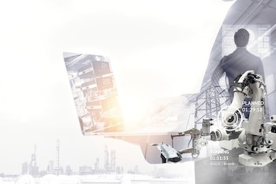 industrial internet of things , disruption technology and industry 4.0 concept. double exposure of automate wireless robot arm and man using laptop for control and monitoring system in smart factory.